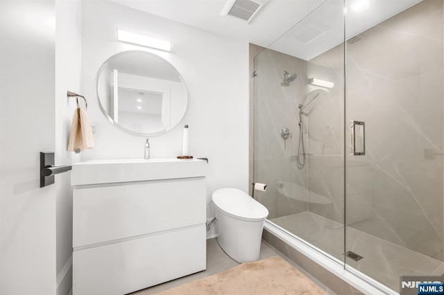bathroom with walk in shower, vanity, and toilet
