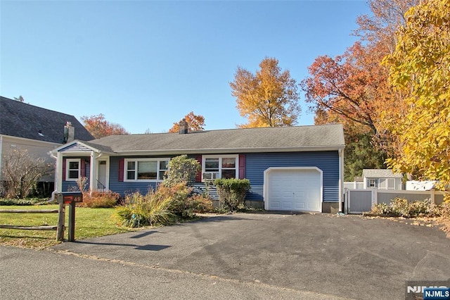 single story home featuring a garage and a front yard