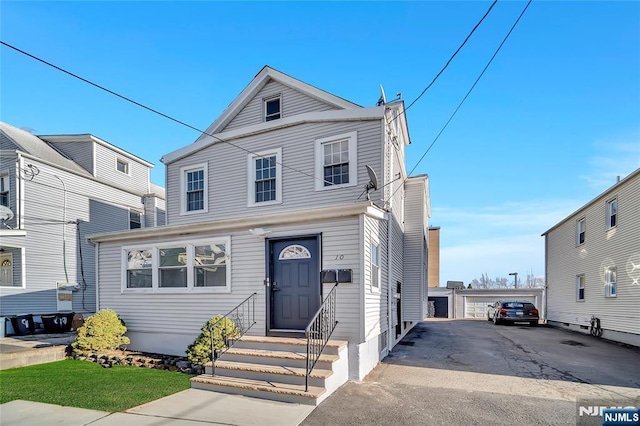 front of property with a garage and an outdoor structure