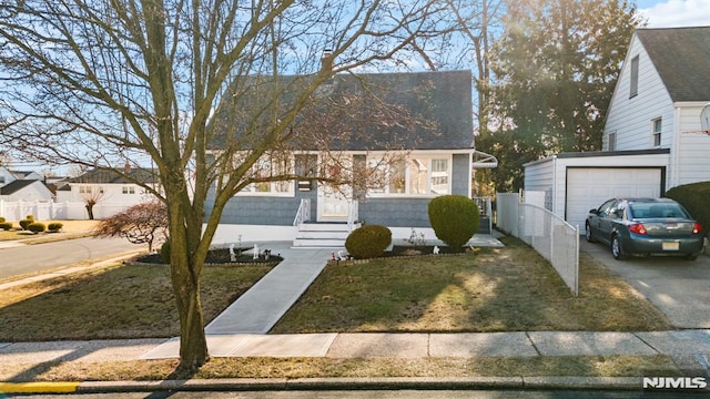 view of front of house with a garage and a front lawn