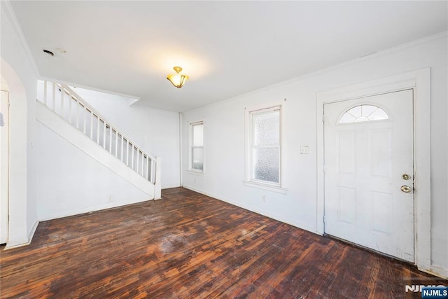 entryway with dark wood-type flooring and ornamental molding