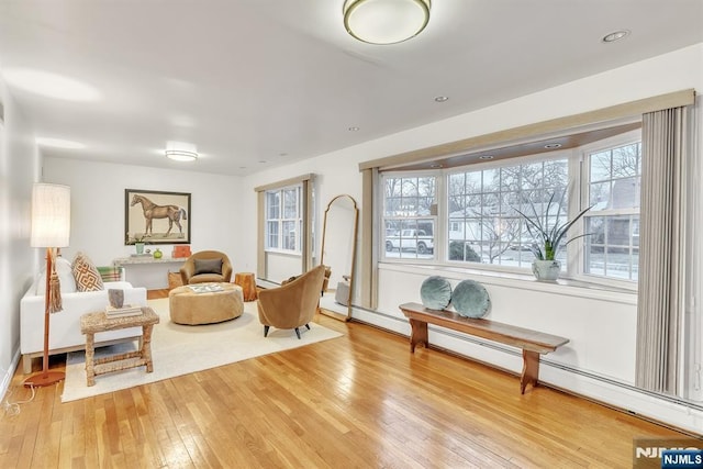 sitting room featuring a baseboard radiator and light hardwood / wood-style floors