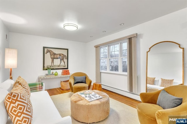 living room featuring hardwood / wood-style floors and baseboard heating