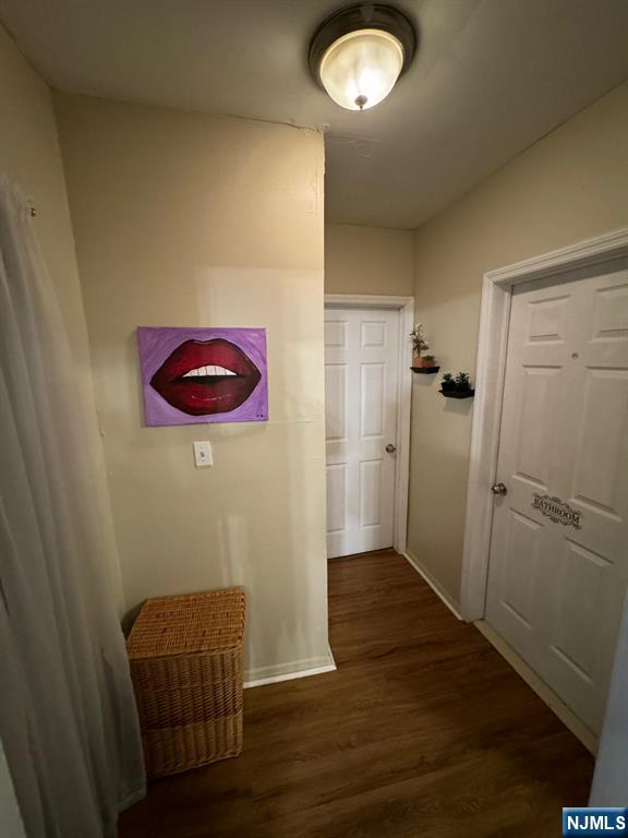 corridor featuring dark hardwood / wood-style flooring