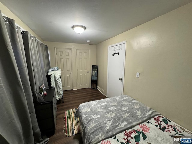 bedroom featuring dark hardwood / wood-style flooring