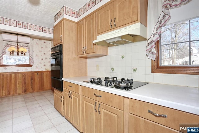 kitchen featuring a wall mounted air conditioner and black gas stovetop