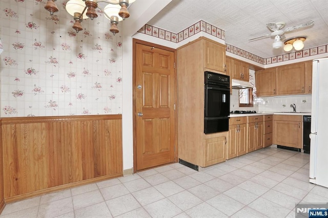 kitchen featuring ceiling fan with notable chandelier, sink, decorative backsplash, and black appliances