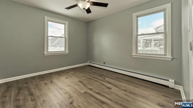 unfurnished room featuring baseboard heating, ceiling fan, and hardwood / wood-style flooring