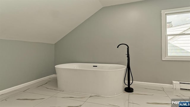 bathroom with vaulted ceiling, a tub, and a baseboard radiator