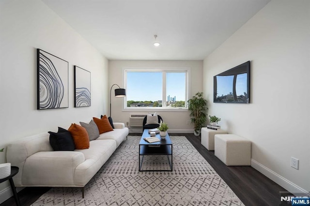 living room featuring dark hardwood / wood-style floors and a wall mounted AC