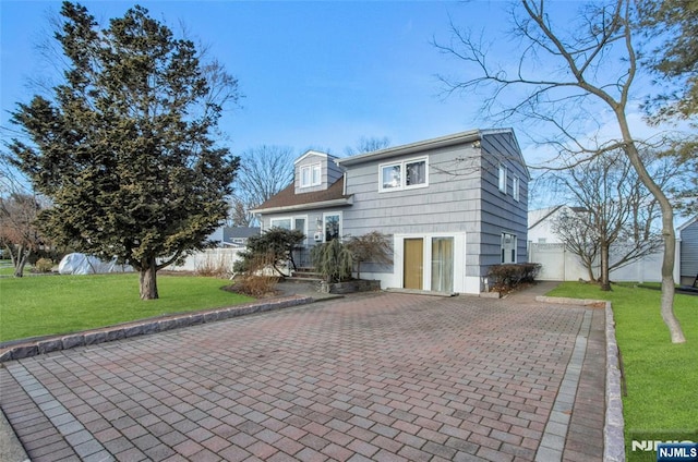 view of front facade with a patio and a front lawn