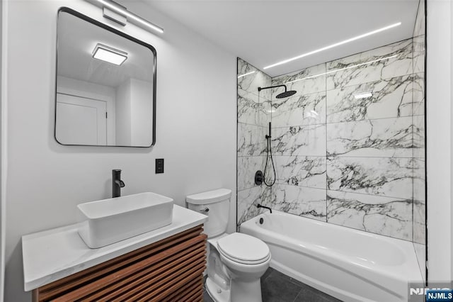 full bathroom with vanity, tile patterned floors, toilet, and tiled shower / bath