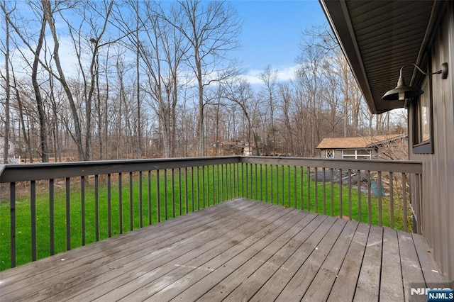 wooden terrace with a lawn