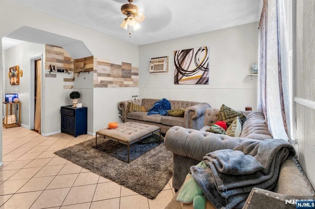 living room featuring ceiling fan, a wall mounted AC, and light tile patterned floors