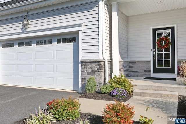 view of exterior entry with a garage