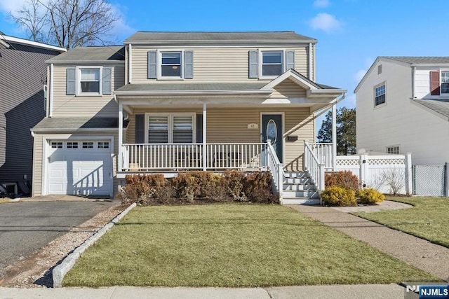 front facade featuring a garage, covered porch, and a front yard