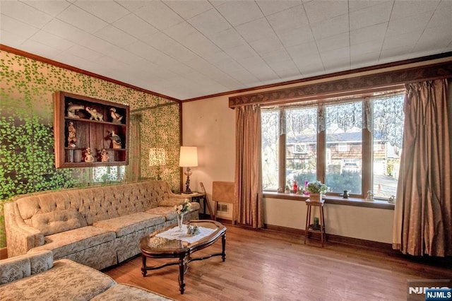 living room with hardwood / wood-style flooring and ornamental molding