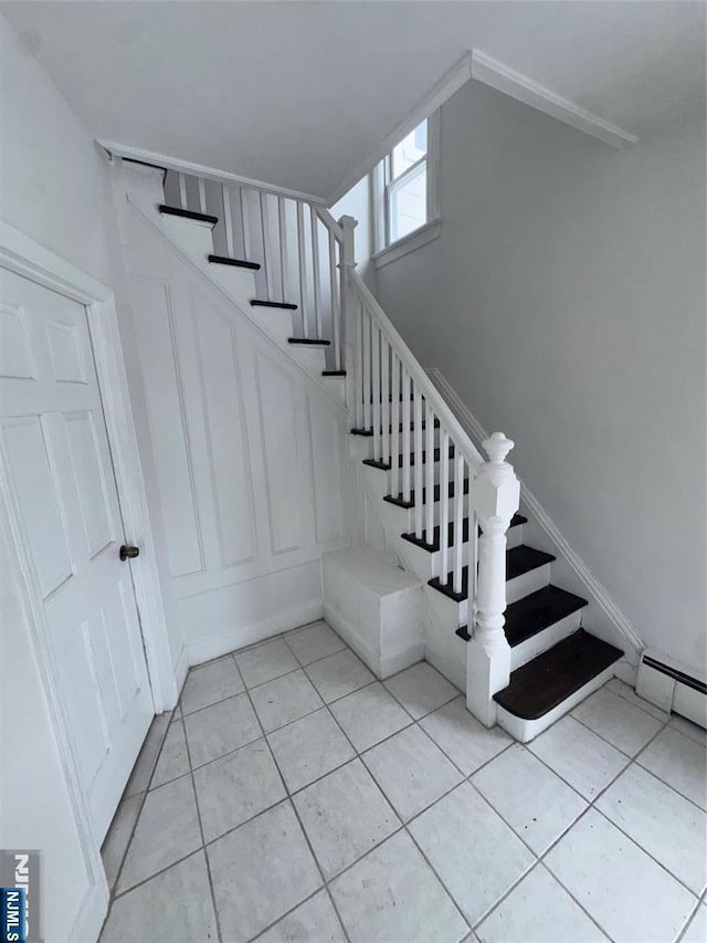 stairway with tile patterned floors