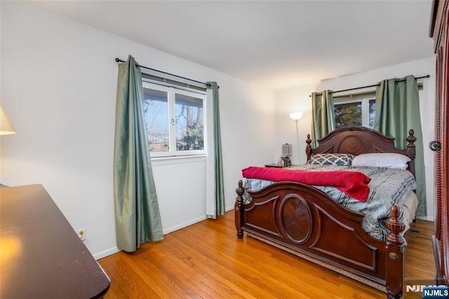 bedroom featuring light wood-style floors and baseboards