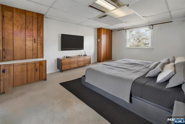 bedroom featuring a paneled ceiling, light carpet, and visible vents