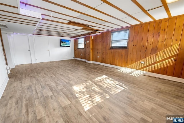 unfurnished living room with wooden walls and wood finished floors