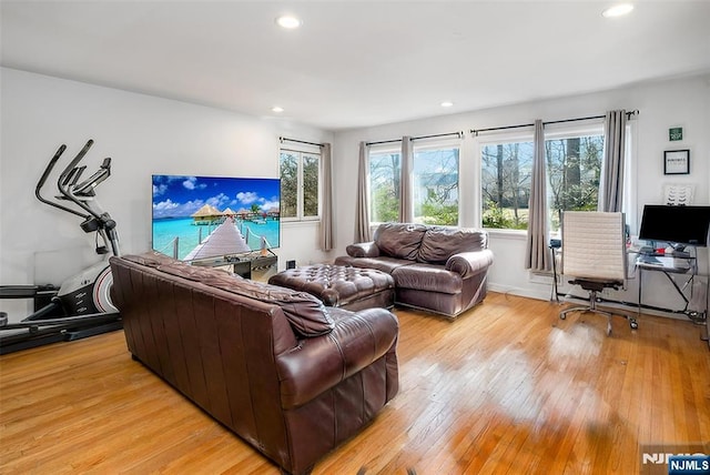 living area with light wood-type flooring and recessed lighting