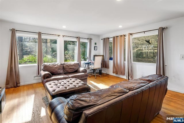 living area with light wood finished floors, recessed lighting, and baseboards