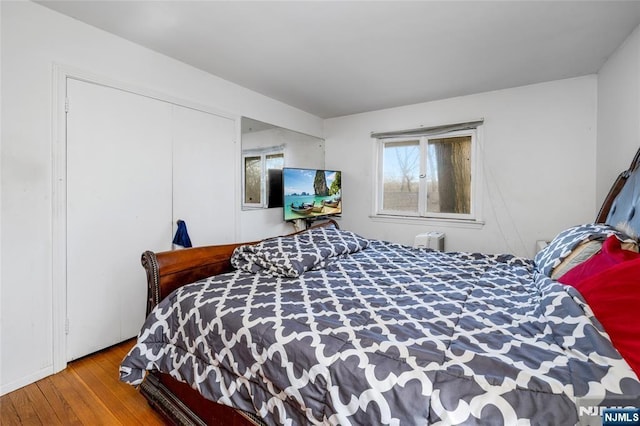 bedroom featuring a closet and wood finished floors