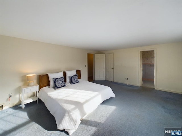 bedroom featuring dark carpet and a closet