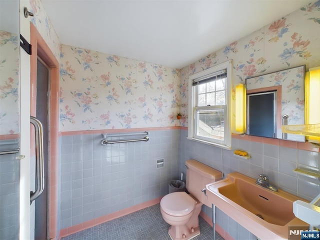 bathroom featuring sink, tile walls, tile patterned floors, and toilet