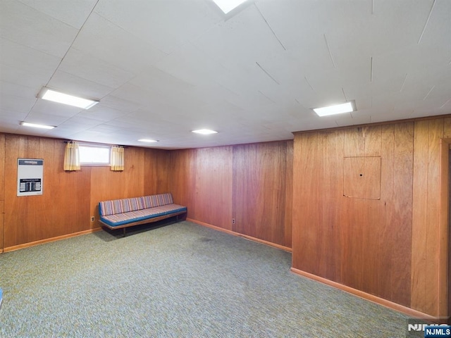 basement featuring heating unit, wooden walls, and carpet flooring