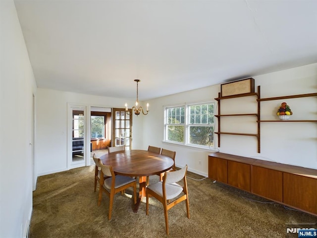 carpeted dining room with an inviting chandelier