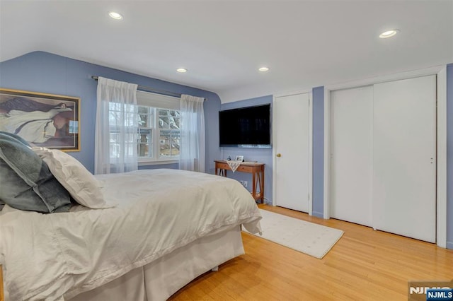 bedroom with vaulted ceiling, wood finished floors, and recessed lighting