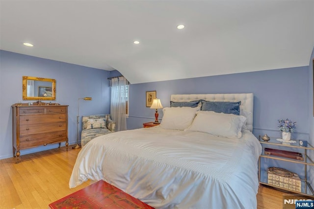 bedroom with light wood-style flooring, baseboards, vaulted ceiling, and recessed lighting