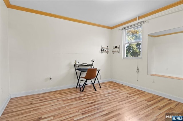 empty room featuring ornamental molding and light wood-type flooring