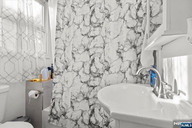 bathroom featuring sink and toilet