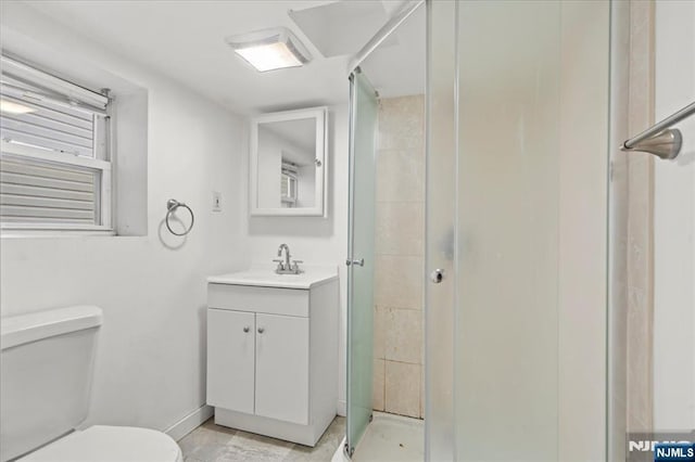 bathroom featuring vanity, toilet, and walk in shower