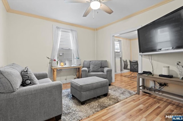 living room with cooling unit, ceiling fan, ornamental molding, and hardwood / wood-style floors