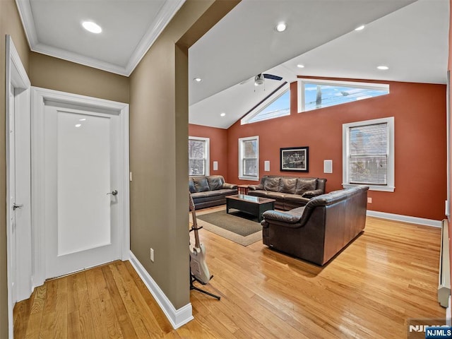 living room with crown molding, lofted ceiling, light wood-type flooring, and ceiling fan