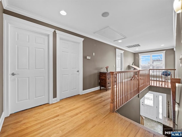 corridor with crown molding and light wood-type flooring