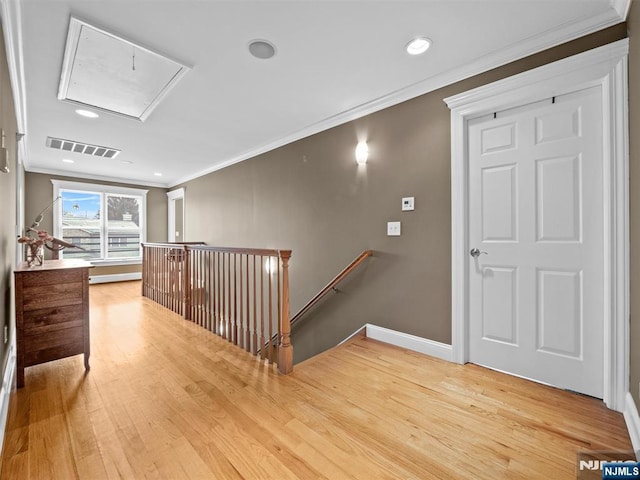 hall with crown molding and light wood-type flooring