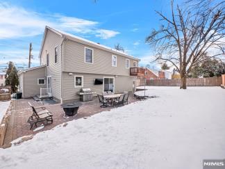 view of snow covered back of property