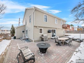 rear view of house featuring a fire pit