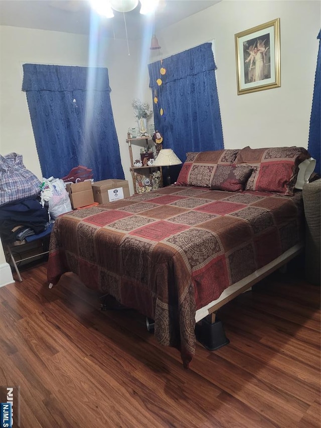 bedroom with hardwood / wood-style flooring