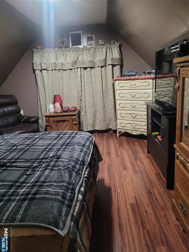 bedroom with dark hardwood / wood-style flooring and vaulted ceiling