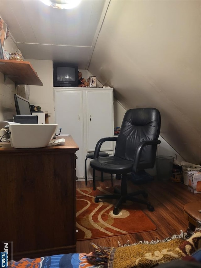 home office with hardwood / wood-style flooring and vaulted ceiling