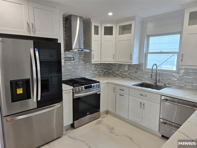 kitchen featuring white cabinets, appliances with stainless steel finishes, sink, and wall chimney range hood