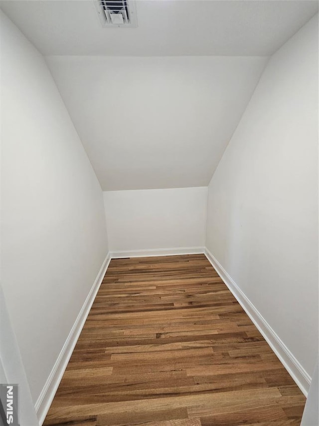 bonus room with wood-type flooring and lofted ceiling