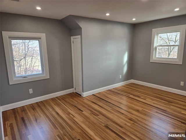 spare room with hardwood / wood-style floors