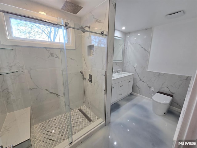 bathroom featuring a shower with door, vanity, tile walls, and toilet